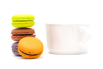 Tower of sweet macarons and a cup of hot tea