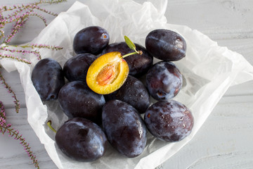 Plums on the grey wooden background 