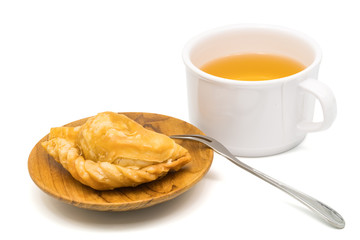 Delicious Curry Puff in a wooden plate and a cup of tea