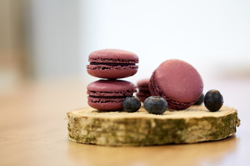 blueberry macarons on wooden stand