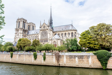 Side view on the Notre Dame church during the cloudy weather in Paris