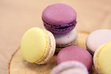 close up of different macarons on wooden stand
