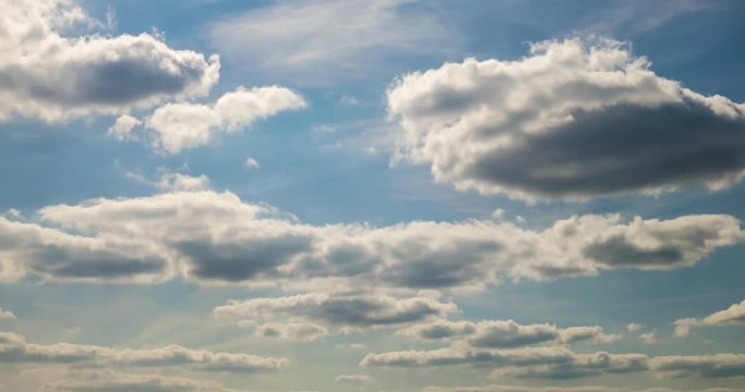 Time lapse clip of white gray fluffy curly rolling clouds
