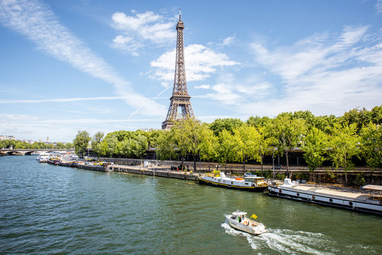 Landscape view on the Eiffel tower and Seine river with boat in Paris