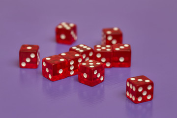 Group of red dices on purple background
