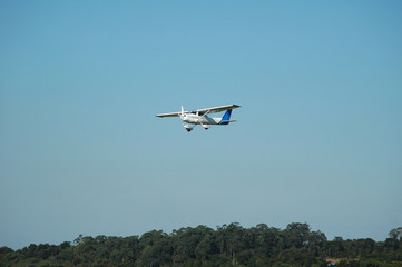 single engine monoplane landing in a small town airport