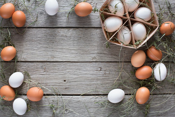 Fresh chicken brown eggs in carton on rustic wood background