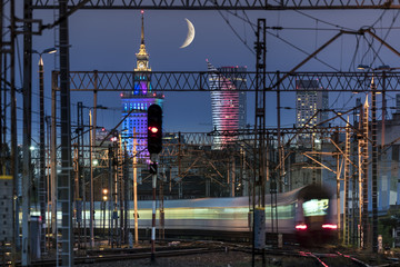 Partial moon over Warsaw city and train junction