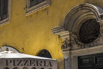 Old cozy street in Rome and typical Italian pizzeria. Architecture and landmark of Rome, Italy