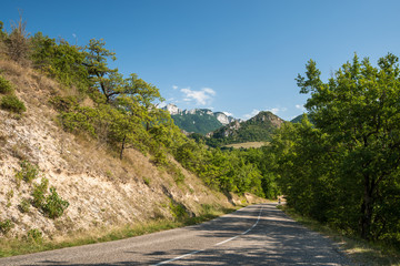Fototapeta na wymiar Long winding asphalt road through the mountains.