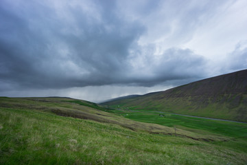 Fototapeta premium Iceland - Rain coming to green natural valley