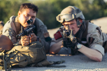 Pair of Army Rangers with rifle and machine gun.They are ready to start firing if enemy appear. Outdoor location shot