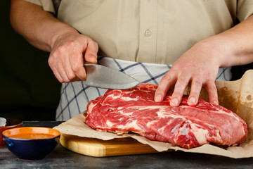 Obraz na płótnie Canvas Close up of Male hands chopping knife pork