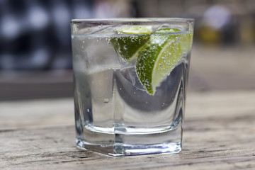 Gin and tonic with slice of lime in a glass