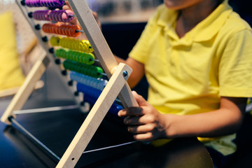 Educational colorful wooden abacus beads on table background. School arithmetic symbol, calculating...