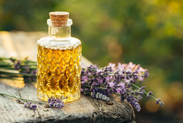 Lavender essential oil in bottle and lavender.