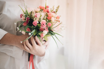 A bridal holding beautiful bouquet, wedding or love concept