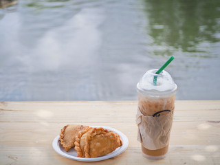 ice coffee with curry on wooden table.