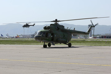 Naklejka na ściany i meble Military helicopters at the airport