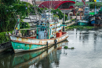 Fototapeta na wymiar Many fishing boats docked in the canal