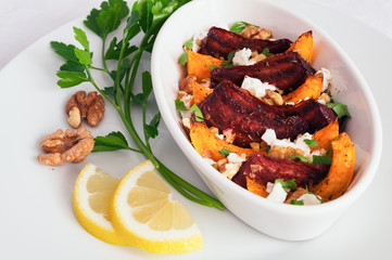 vegetable salad with feta and walnuts decorated with lemon and parsley