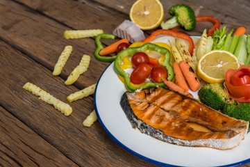 Salmon fillets. Grilled salmon, salmon steak on old wooden table, vintage style