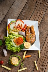 Salmon fillets. Grilled salmon, salmon steak on old wooden table, vintage style