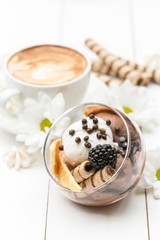 Ice cream with coffee in the background on white table