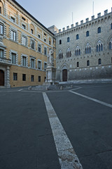 Fototapeta na wymiar The Salimbeni Palace and the statue of Sallustio Bandini in Siena, Tuscany district. Italy