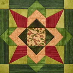 Bright orange-green geometric patchwork block from pieces of fabrics