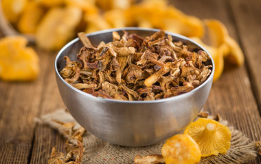 Wooden table with Dried Chanterelles, selective focus