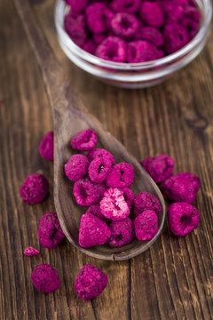 Wooden table with Dried Raspberries, selective focus