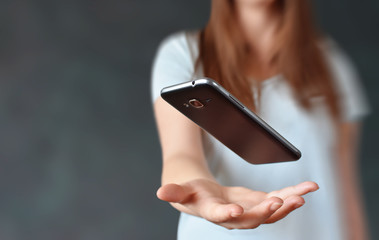 Phone floating above girl hand, technology concept for adding icons, text, etc