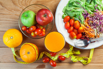 Healthy concept with mixed fruits and vegetables on wooden background