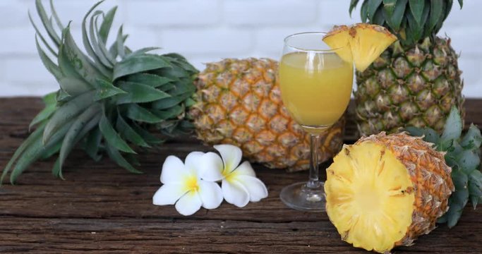 Pineapple with Juice on wood table background .