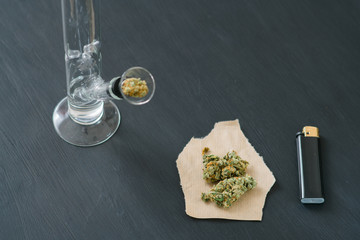 Bong and marijuana, cannabis thc flower Sativa and Indica Close up on a black background. lifestyle...