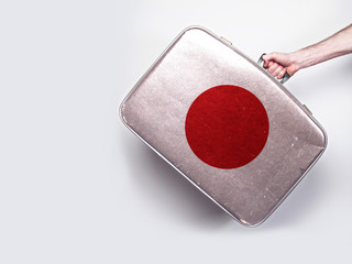 Japan flag on a vintage leather suitcase.