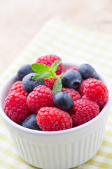 Oatmeal porridge in bowl with berries raspberries and blackberries.
