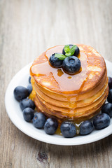 Stack of pancakes with blueberry and fresh berry.