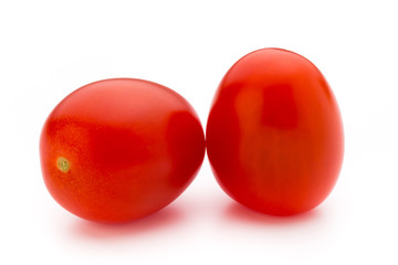 Small plum tomatoes on a white background.