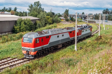 Naklejka premium Attached to each other electric locomotive and diesel locomotive at the turn of the Iron Dog