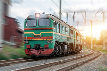 Obraz premium Locomotive rides at speed at the turn of the railway