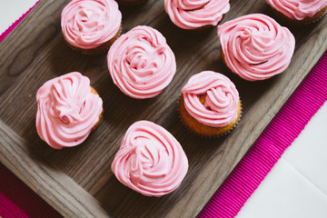 freshly baked muffins cupcakes on a natural wooden board