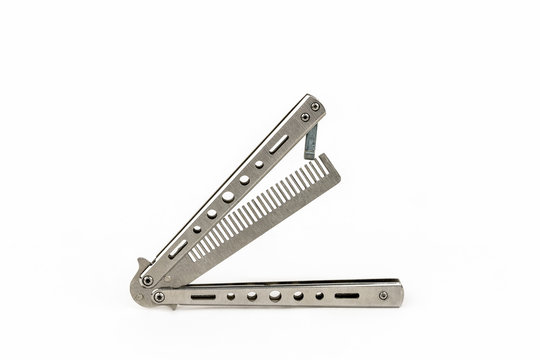 Hair care product, unusual folded butterfly steel comb isolated on white. Studio shot.