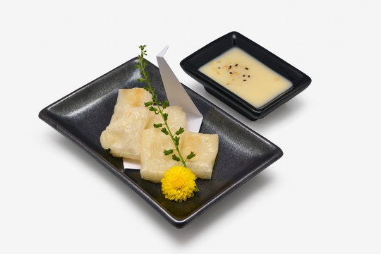 Mochi Yaki (Grilled Japanese Mochi Flour) In Black Plate On White Background