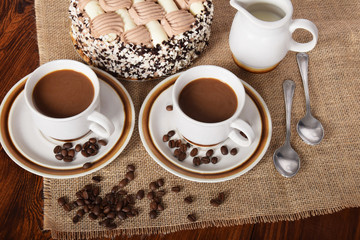 cups of coffee and milk and roasted coffee beans