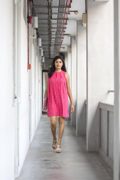 Beautiful Indian lady walking along the corridor