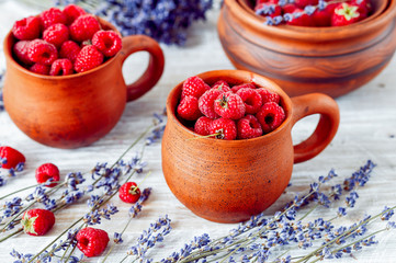 pottery with raspberries and lavender on wooden table