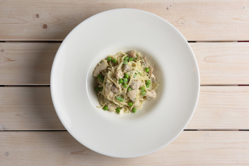 Plate of spaghetti with green pease