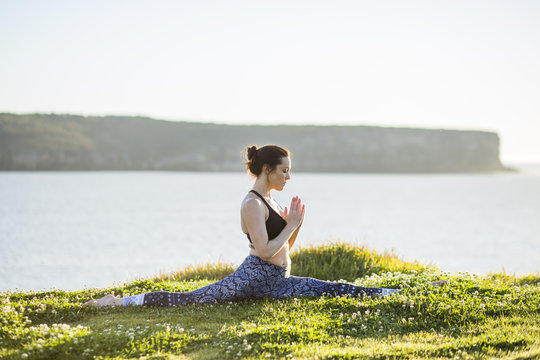 A female yogi practicing at sunrise